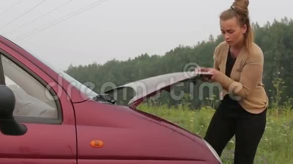 女人检查汽车的油位视频的预览图