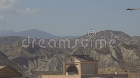 雄伟的沙漠山脉在房子的背景下视频的预览图