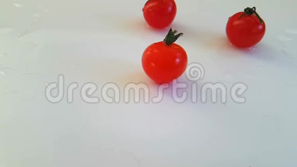 樱桃番茄在白色背景下变湿慢镜头拍摄视频的预览图