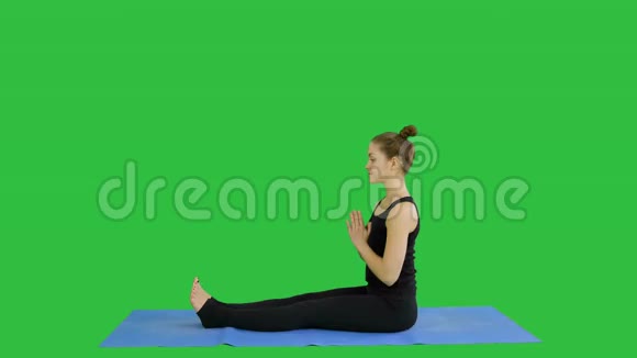 年轻女孩在绿色屏幕上做伸展运动Chroma键视频的预览图