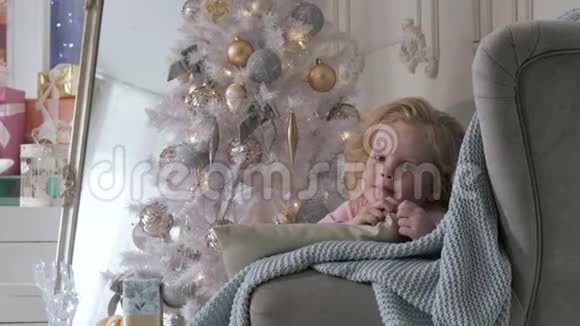 那个女孩躺在工作室的沙发上圣诞节室内视频的预览图