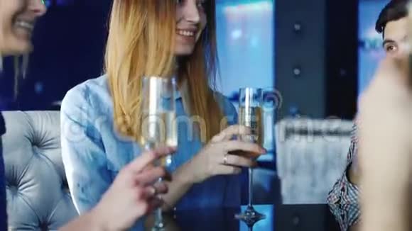 年轻漂亮的女人在餐厅的餐桌上接受朋友的祝贺所有的玻璃碎片视频的预览图