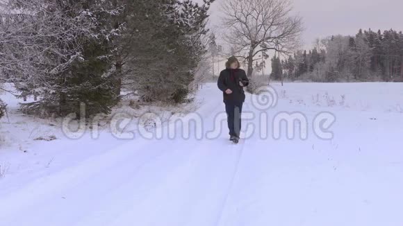 冬季雪道上有专业摄影摄像的男子视频的预览图