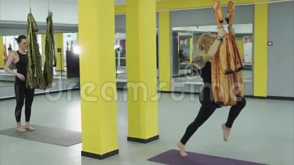 女孩在飞行瑜伽中做体式这有助于提高弹性视频的预览图