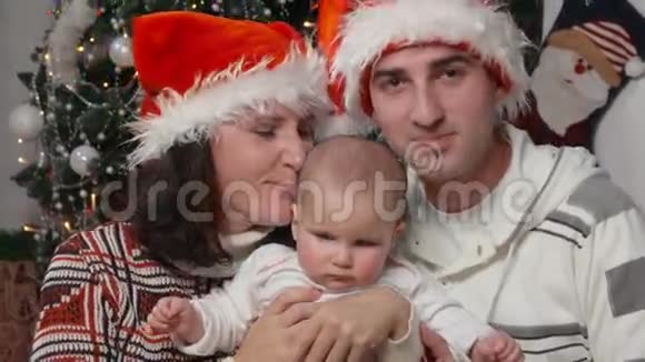戴着圣诞帽和宝宝幸福家庭视频的预览图