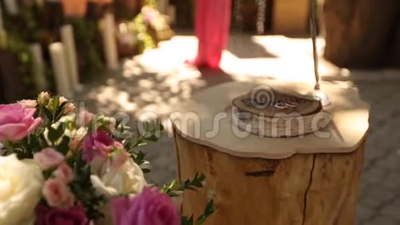 乡村风格的婚礼装饰与美丽的花朵组成的粉红色和白色玫瑰绳子在树桩上视频的预览图
