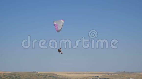 极端滑翔伞飞行在一个晴朗的蓝天阳光照射到相机滑翔伞飞行体验跳伞视频的预览图
