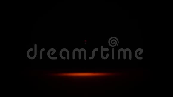 水在黑色背景上的橙色灯光下滴落红色液体滴视频的预览图