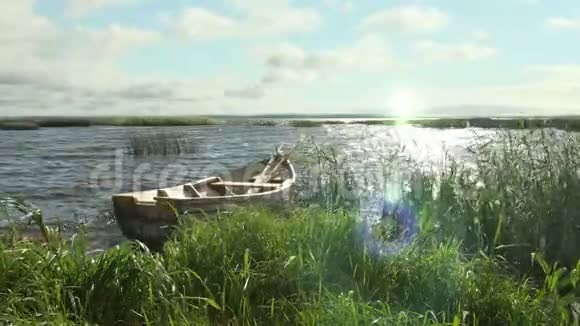 日落时分芦苇湖上的旧木船的时间推移视频的预览图