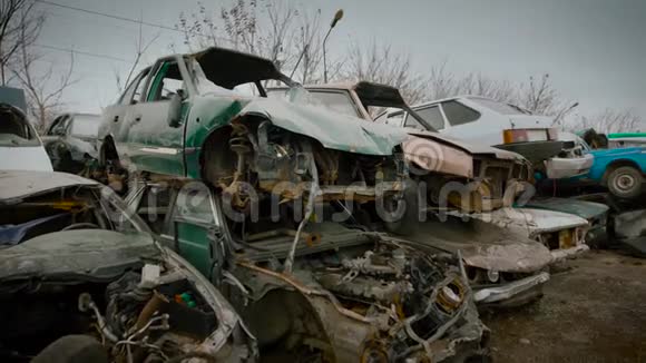 汽车堆填区上的破车的近距离拍摄生锈和破碎的汽车正在等待视频的预览图