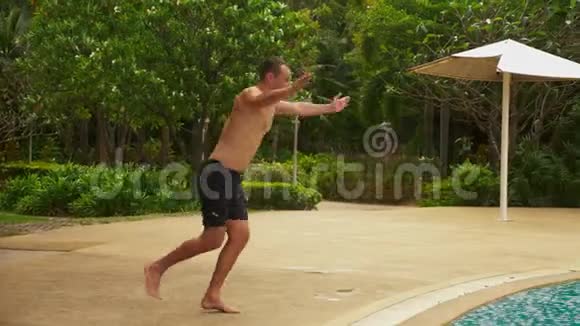 快乐的年轻帅哥跳进游泳池在酒店度假暑假旅游概念视频的预览图