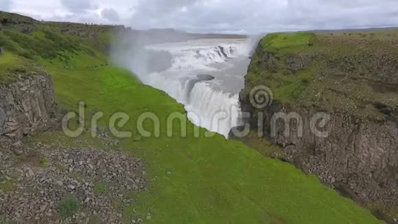 冰岛的瀑布环绕着绿油油的山脉安德列夫视频的预览图