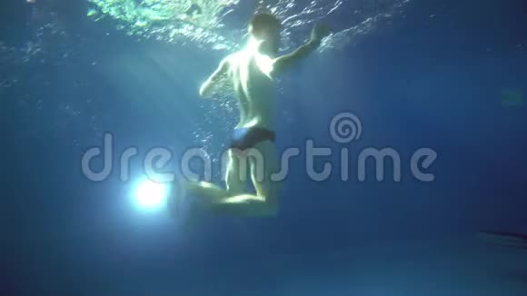 一个年轻人在水下翻筋斗他在镜头前摆姿势水下景观视频的预览图