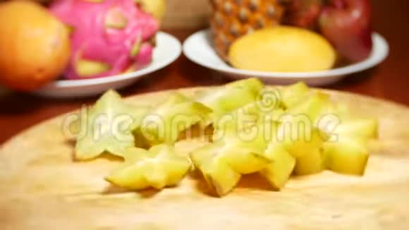 餐桌上的异国水果一只杨桃切成块在切割板上旋转视频的预览图