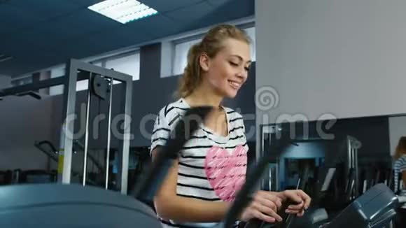 在健身房训练的漂亮女人微笑着视频的预览图
