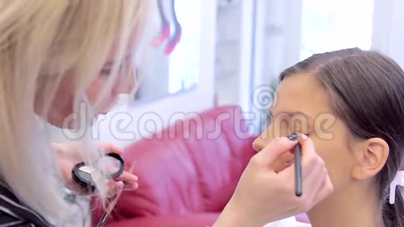 化妆师在模特眼睛上的眼影视频的预览图