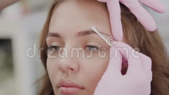 化妆师在手术前用凝胶润滑客户的眉毛视频的预览图