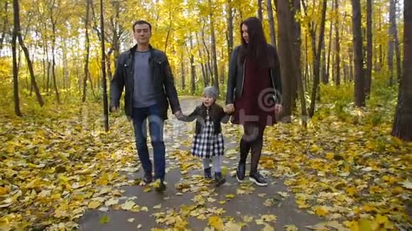 一家人和一个小女儿在秋天公园散步视频的预览图