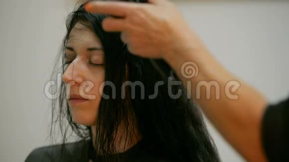 美容和人的概念幸福的年轻妇女与理发师造型头发与吹风机在美发店视频的预览图
