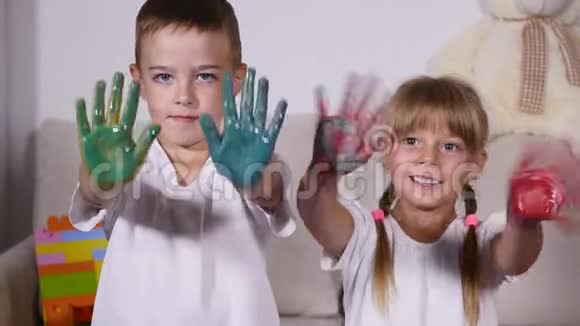 两个快乐的孩子展示了他们被玷污的手掌视频的预览图
