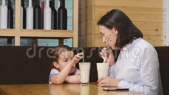 妈妈和可爱的小女孩在咖啡馆吃早餐视频的预览图
