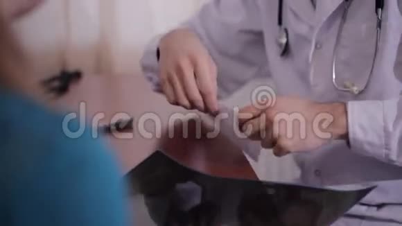 男医生在一张纸上为一个有耐心的女孩写建议医生通过了一份药品清单视频的预览图