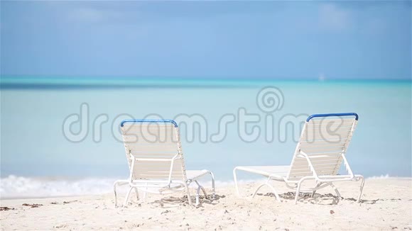 马尔代夫美丽的热带海滩上有两张躺椅视频的预览图