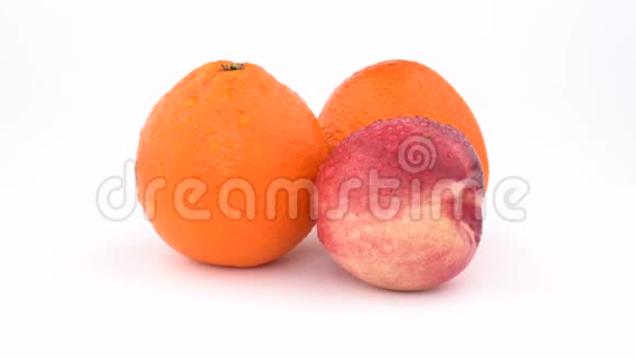 汁橙果实曼达林和油桃水滴在白色背景上旋转孤立无援快关门视频的预览图