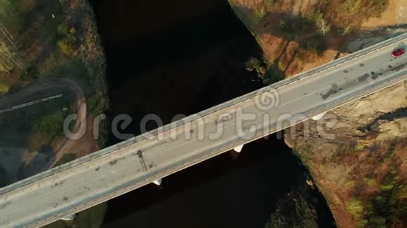 横跨河流的桥上汽车交通的高空俯视图视频的预览图