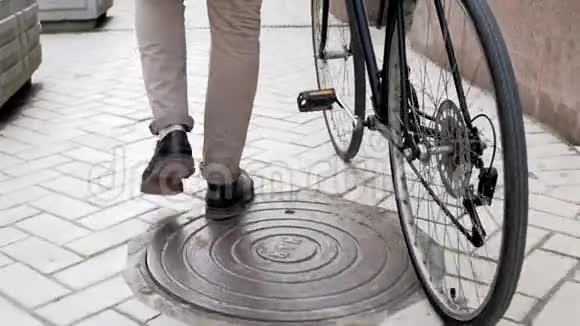 年轻的嬉皮士走在街边的老式自行车旁边视频的预览图