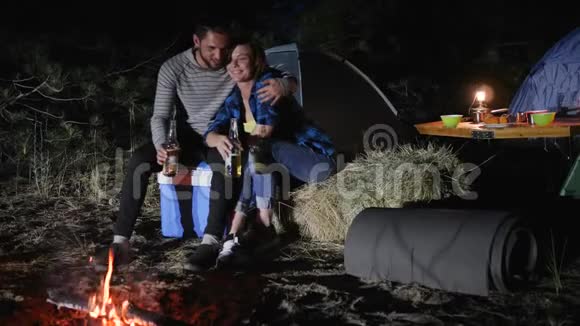 男女旅行营地进入林地浪漫的夜晚情人在森林里搭帐篷年轻夫妇视频的预览图