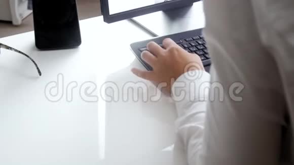 4kstealycam镜头年轻女子坐在办公桌后在电脑上工作视频的预览图