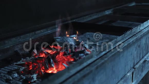 近距离观看烧烤架中燃烧的木炭和火焰浅的景深视频的预览图
