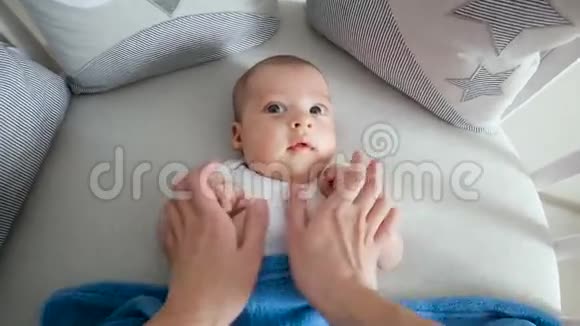 妈妈和躺在圆床上的婴儿玩耍视频的预览图