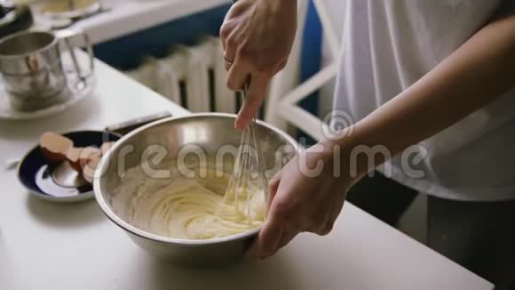 准备自制煎蛋卷的人用手花冠混合鸡蛋视频的预览图