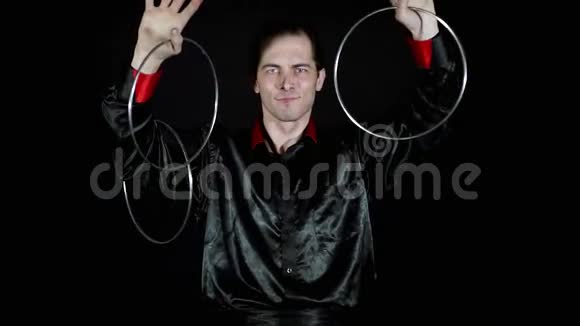 魔术师操纵黑色背景上的铁箍视频的预览图