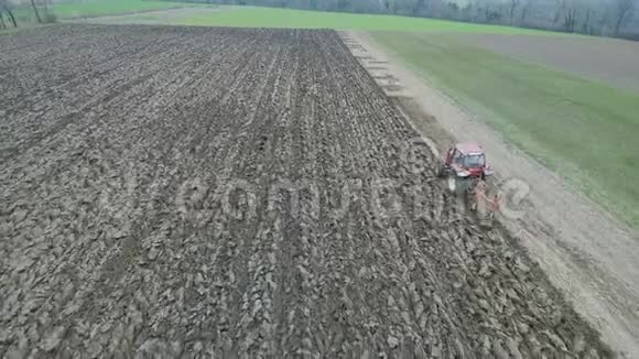 农业和农业拖拉机在早春的航片中耕田视频的预览图
