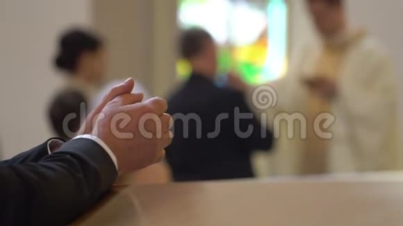 在教堂跪在皮尤的人的手被扣住视频的预览图