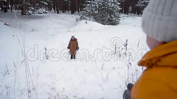 爸爸和女儿在冬天滑雪女孩和男人爬上雪山冬天在公园里玩家庭游戏视频的预览图