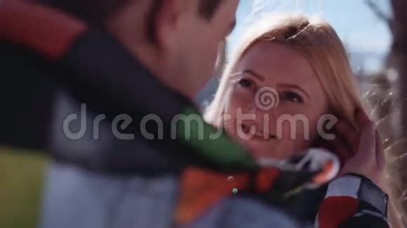 在雪山顶上很少有一对漂亮的年轻夫妇他抚摸着她的金发他们温柔地接吻视频的预览图