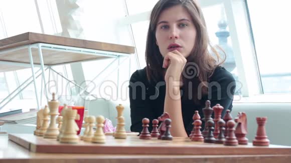 女人在室内下棋和思考位置找到制胜之招策略无聊视频的预览图