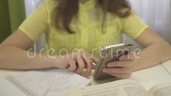 十几岁的女孩在做家庭作业时使用智能手机股票录像视频的预览图
