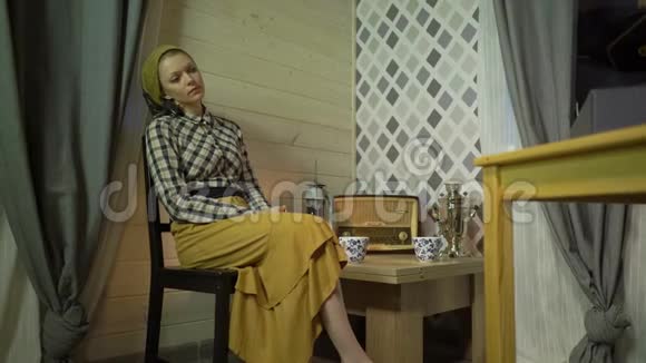 疲惫的裁缝女孩休息喝茶放松听音乐在乙烯基板留声机或留声机复古视频的预览图