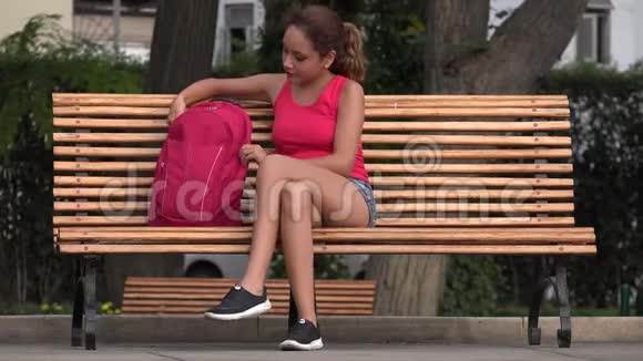 女大学生在公园长椅上休息视频的预览图