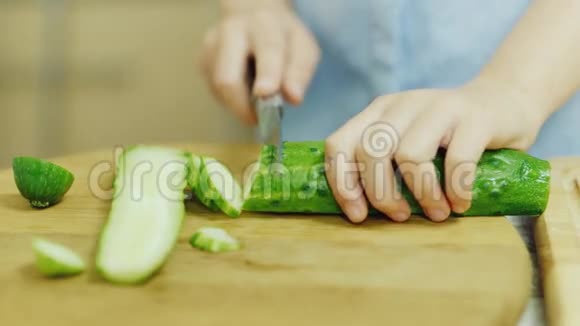 学做饭一个女孩正在学习做沙拉切黄瓜视频的预览图