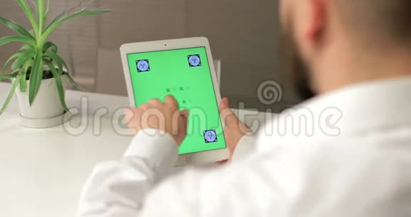 商人使用平板电脑与绿色屏幕他滑动和触摸屏幕办公室是明亮和现代的视频的预览图
