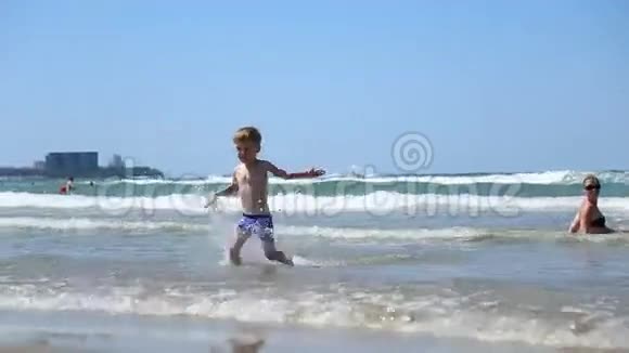 小男孩在海浪中奔跑视频的预览图