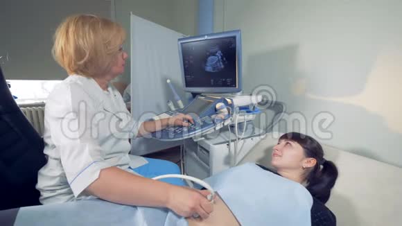 女性妇科医生和超声波检查期间的孕妇视频的预览图