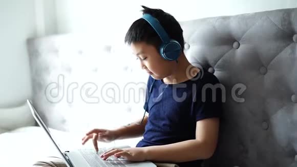 小男孩在家玩电脑游戏放松视频的预览图
