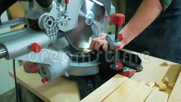 一个木匠正在工作室里用一台特殊的机器加工木材接头使用圆形锯床视频的预览图